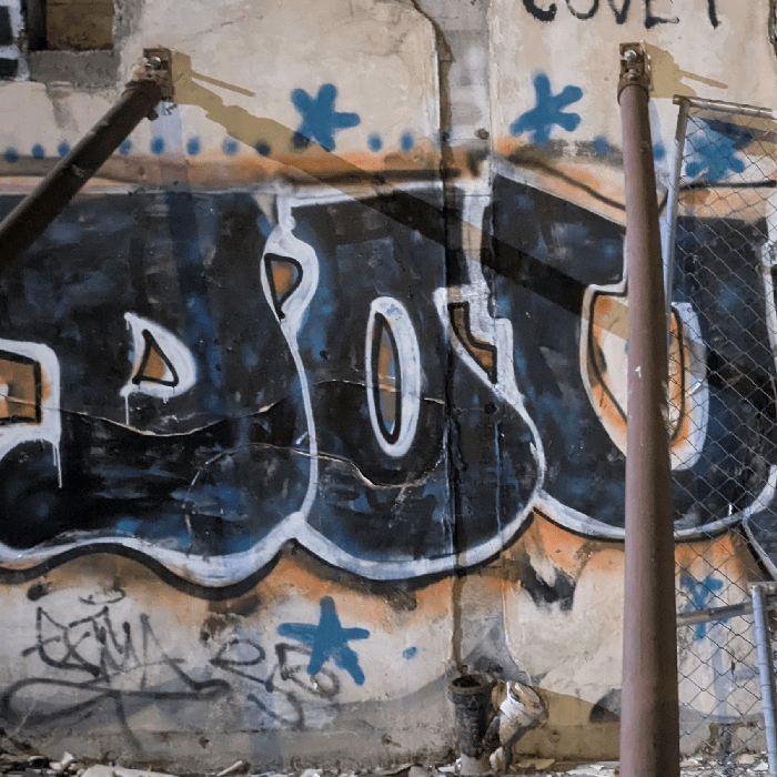 The letters DOU are spraypainted on the rubble of a torn down building